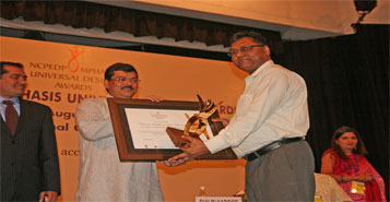 Sh.U N Khaware receiving the NCPEDP Mphasis Universal Design Award from Sh. Mukul Wasnik, Hon'ble Minister for Social Justice and Empowerment, Govt. of India